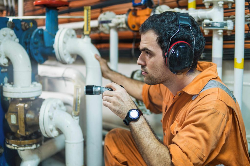man looking at pipework | Safety Compliance in Hydraulics | HOS.co.uk